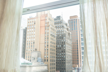 Fototapeta na wymiar New York City, USA urban cityscape building skyscrapers in NYC Herald Square vintage view through window and curtains