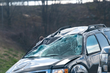 Closeup of car accident of vehicle crash, wreck on interstate highway road with broken windshield...