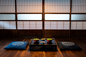 Traditional japanese machiya house or ryokan restaurant with black lacquered wood table and edamame...