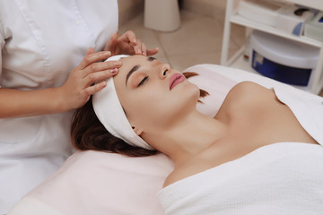 Fototapeta na wymiar Face Massage of a Young Woman Getting Spa Treatment.