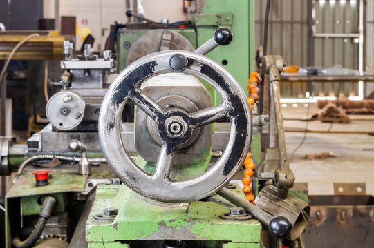 Crank wheel on industrial lathe machine in factory