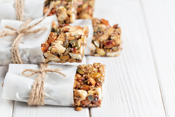 Homemade Superfood breakfast bars with roasted nuts as almond, cashew nut, pumpkin seeds, sesame seeds, honey on white background – Image