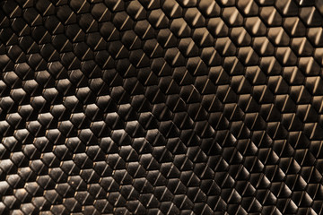 black metallic honeycomb grid texture pattern. dark background