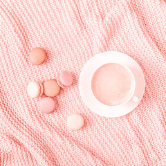 Background with pink plaid, coffee and macaroons.