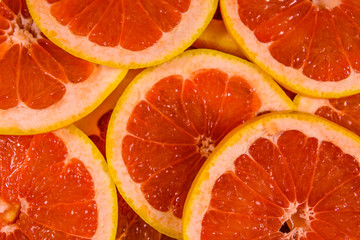Background of sliced juicy grapefruit. Healthy eating