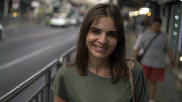 Portrait of happy, pretty woman walking in city