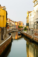 Narrow canals are famous and typical in Venice.