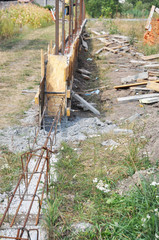 Building concrete pouring slabs formwork foundation for new fence. House fencing construction