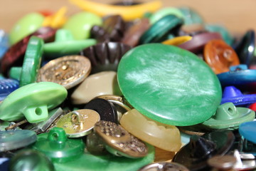 Obraz na płótnie Canvas A lot of multicolored different size old buttons