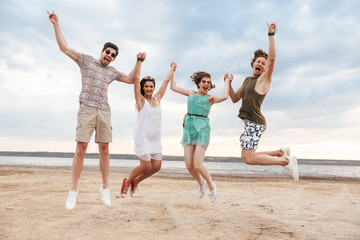 Group of a cheerful young friends jumping