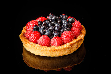 closeup shortbread mini tart with custard and berries