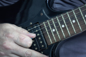 Close-up of man playing lead guitar solo