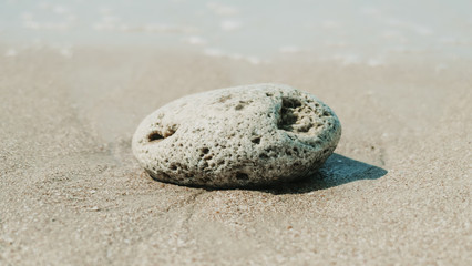 Fototapeta na wymiar Close up of a stone at the seashore