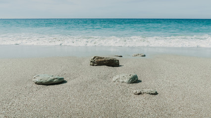 breaking wave at the shore with clear water