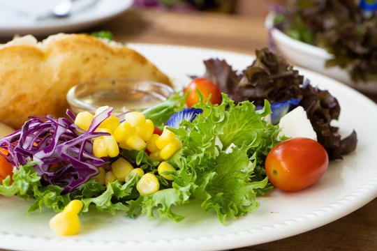 Salad side dish on a white plate on a wooden table