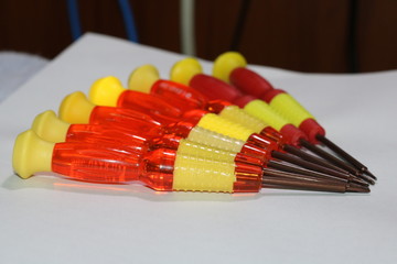 small red-yellow screwdrivers on table