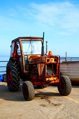 Fototapeta na wymiar Filey England UK June 1 2018 Old rusty tractor used for towing the fishing boats from The cobble landing Filey North Yorkshire - Editorial