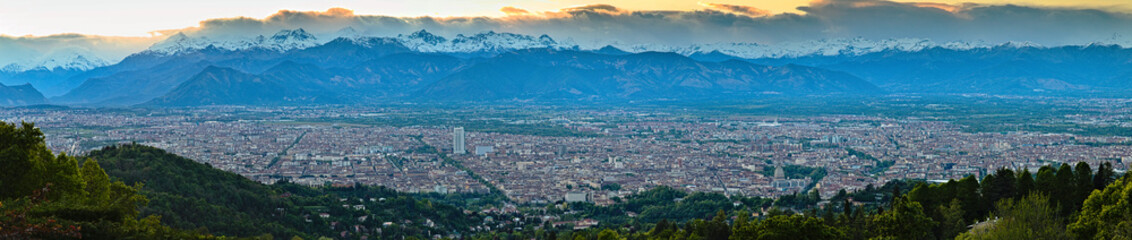 Fototapeta na wymiar Aerial view on Turin city from the hills, sunset landscape and city skyline with Alps on backround