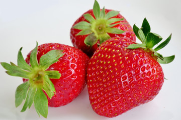 ripe juicy and healthy strawberries on a white background close-up