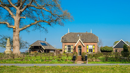 Encountering a gorgeous Dutch traditional farmhouse when walking the Dutch Hiking Tour of the Year near the village of Markelo (Overijssel, The Netherlands). The region is known for beautiful nature