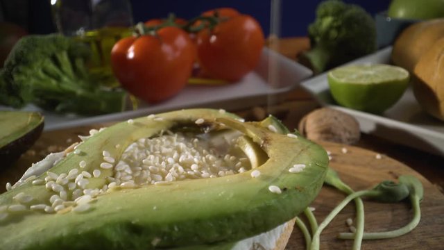 Healthy food. Healthy assortment of vegetables and fruits with legumes: sandwich with avocado and sesame, sprouted grains, fresh bread, lemon, tomatoes, olive oil.