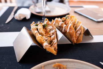 shrimp tacos with guacamole on metal support