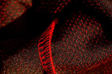 red sportswear closeup top view. seam and juncture inside out. breathable knitwear. clothing details macro