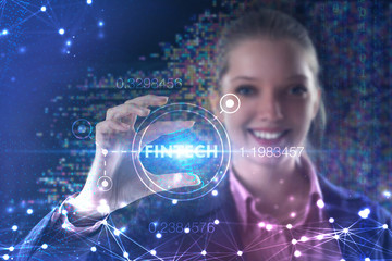 Fototapeta premium The concept of business, technology, the Internet and the network. A young entrepreneur working on a virtual screen of the future and sees the inscription: Fintech