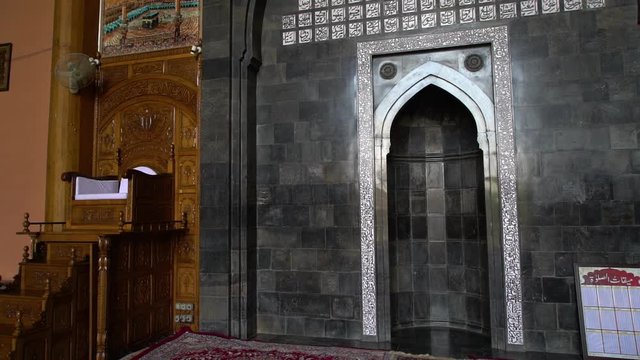 Extreme close-up low-angle still shot of a decorated Mihrab on a wall, indicating the direction of Kabaa in Mecca, Jamia Masjid mosque,  Srinagar.