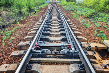 Railway tracks on the big station at day time.