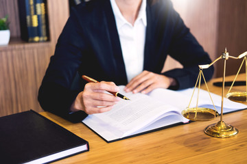 lawyer judge reading documents at desk in courtroom working on wooden desk background. gavel ...