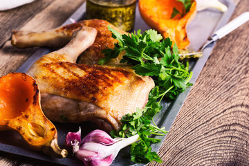 Grilled chicken legs, roasted pumpkin, pesto sauce and fresh parsley