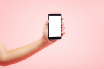 Fototapeta na wymiar Hand holding smartphone with white blank screen on pink background