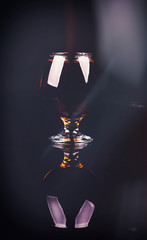 glass with cognac on a black background