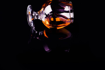 glass with cognac on a black background