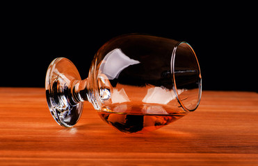 glass with cognac on a black background
