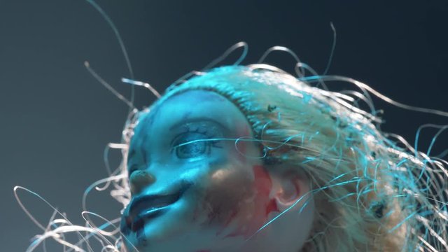 Scary mutilated doll face. Horror concept shot.