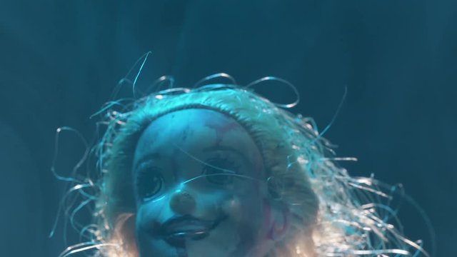 Scary mutilated doll face. Horror concept shot.