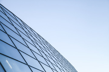 Fototapeta na wymiar Shiny glass wall under blue sky