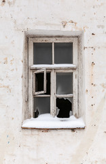 Old broken window in white wall