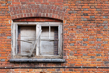Fototapeta na wymiar Old locked window with broken frame