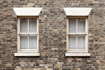 Two similar windows in brick stone
