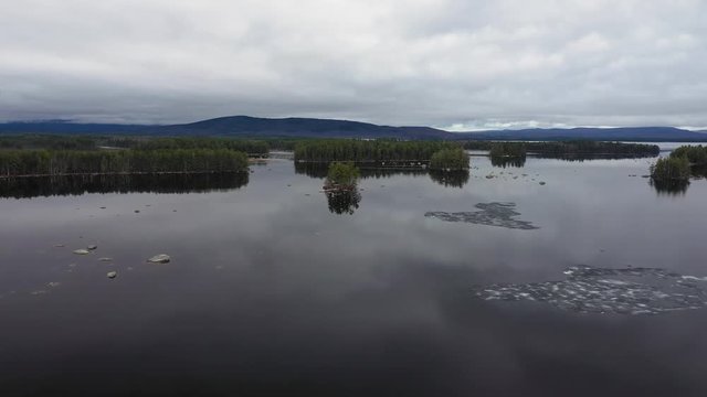 Alone on freezed Millinocket lake in the US escaped from reality and calming the mind on the reflectious, tranquil landscape in a boat.