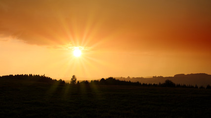 Sunrise over black forest mist. Sky background.