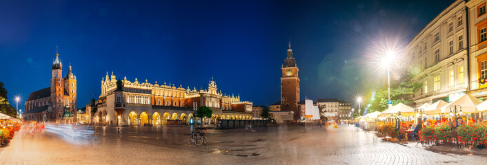 Krakow, Poland. Famous Landmarks On Old Town Square In Summer Evening. St. Mary's Basilica, Cloth Hall Building And Old Town Hall Tower In Night Lighting. UNESCO World Heritage Site. Panoramic View - obrazy, fototapety, plakaty