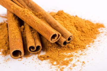 Cinnamon sticks and powder on white background