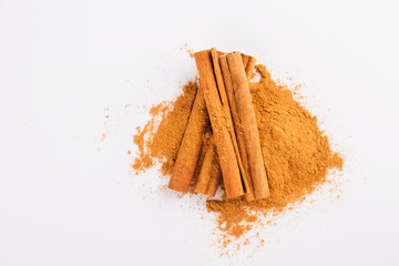 Cinnamon sticks and powder on white background