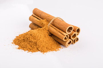 Cinnamon sticks and powder on white background