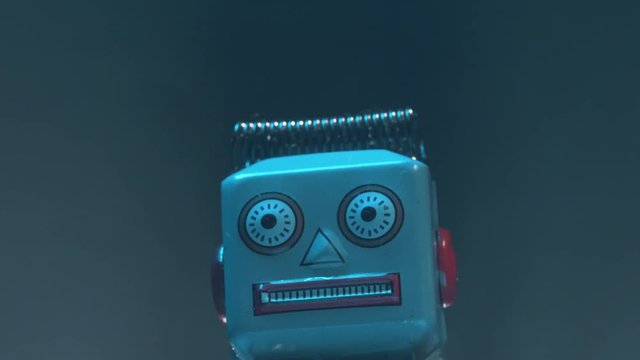 Closeup shot on a vintage robot head with mysterious fog around.