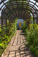 Ornamental garden with a gold statue and a pergola